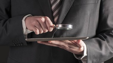  Büyüteç ve dijital tablet kavramı holding iş adamı