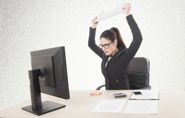 Stressed businesswoman sitting at table in front of computers in — Stock Photo, Image