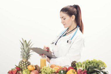 Diyetisyen doktor meyve ile onun masasında