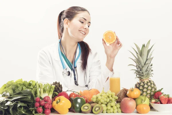 Dietitian doctor on her desk with fruits — Stock Photo, Image