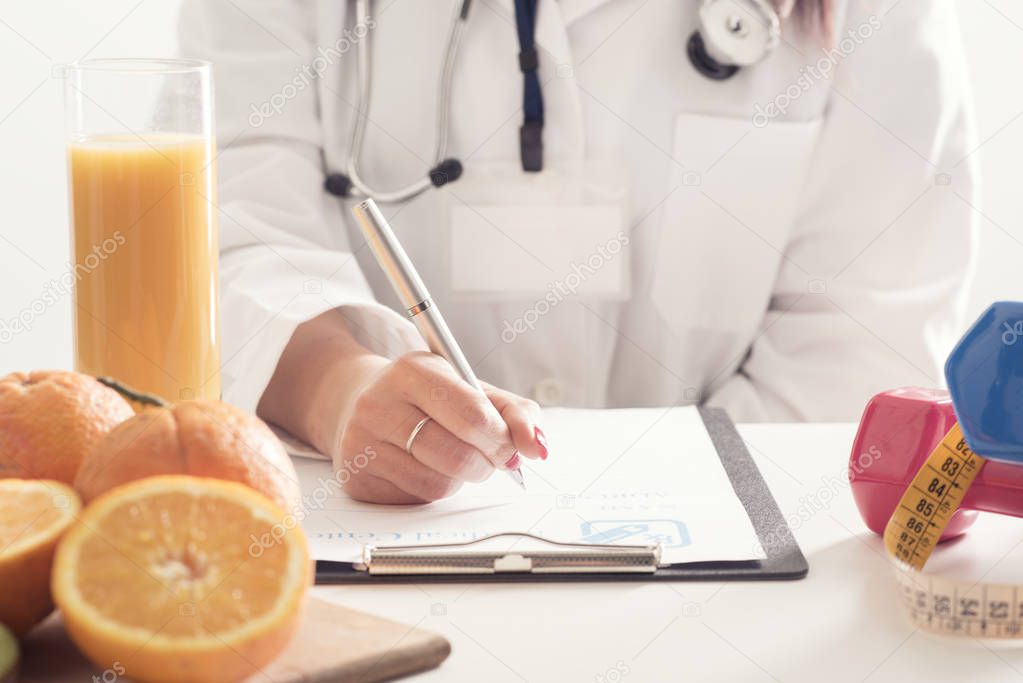 Female Dietician With Fresh fruits and diary