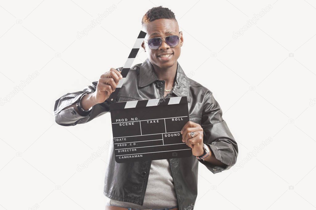 Young African American man holding a clapperboard