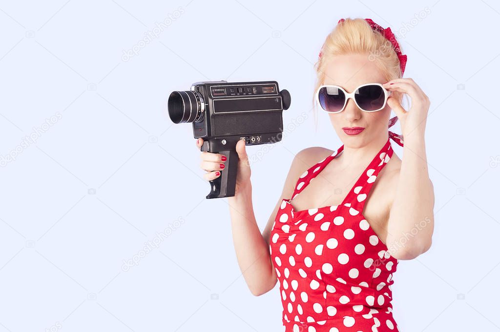 pin-up girl filming old  8 mm videocamera