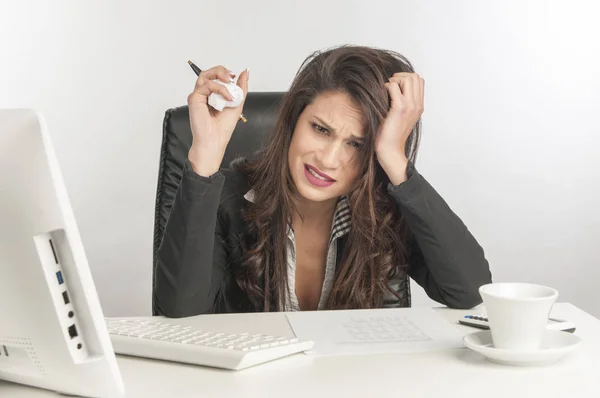 A young businesswoman is looking stressed as she works — Stock Photo, Image