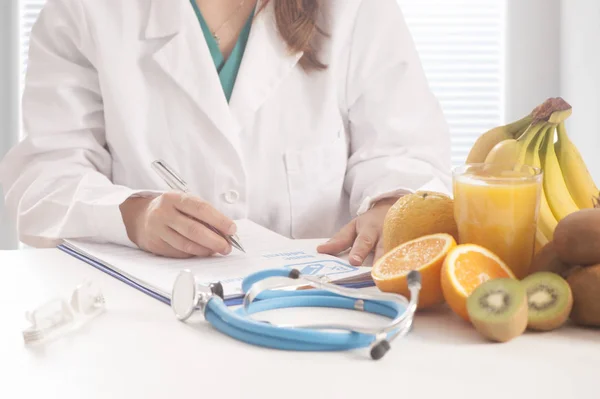 Nutritionist writing medical records and prescription