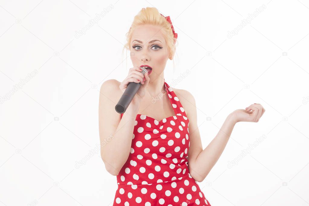 Isolated portrait of a funny pin-up sing star talking into a microphone. Pop star karaoke