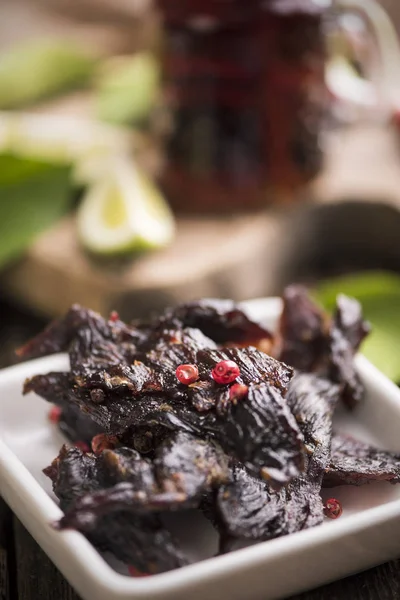 Beef Jerky on wooden background Royalty Free Stock Photos