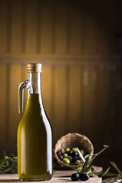Olive oil and olives on wooden rustic table — Stock Photo, Image