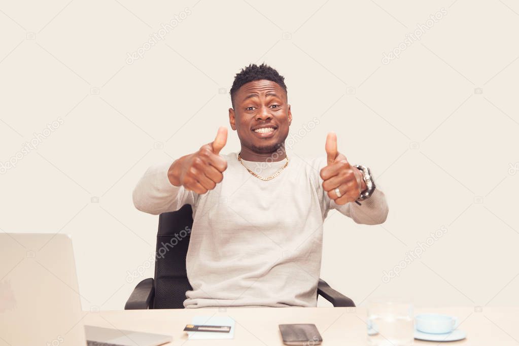 happy successful student, business man winning sitting on desk 