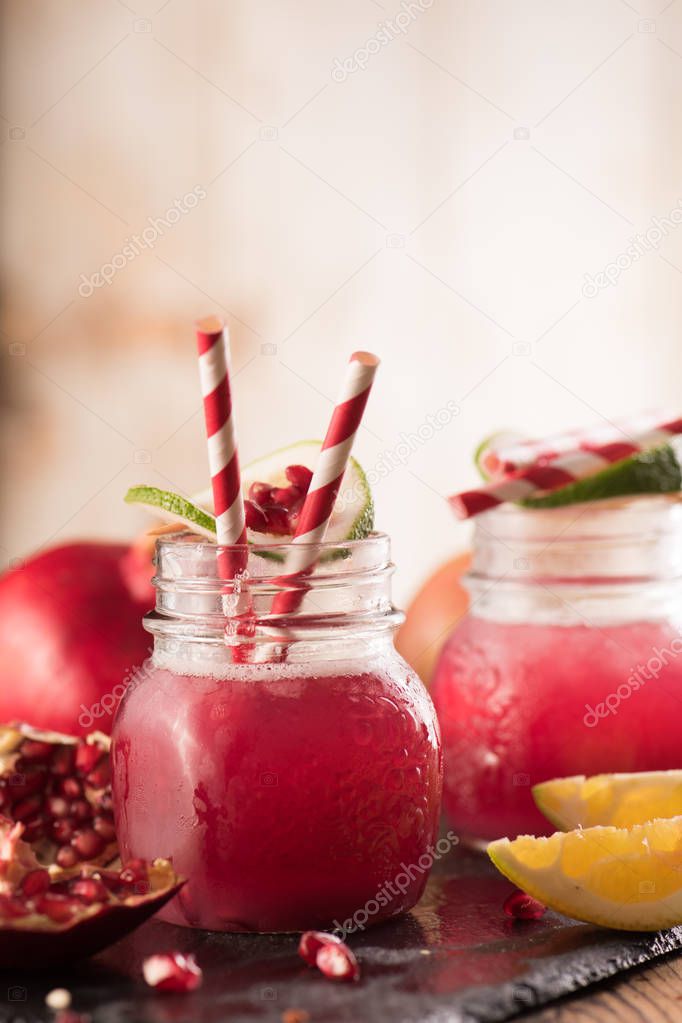 Pomegranate drink on a wooden background. Selective focus.