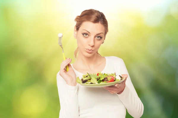 Happy woman eats healthy food vegetable vegetarian salad over a — Stock Photo, Image