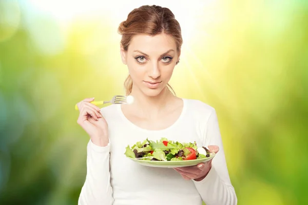 Happy woman eats healthy food vegetable vegetarian salad over a — Stock Photo, Image