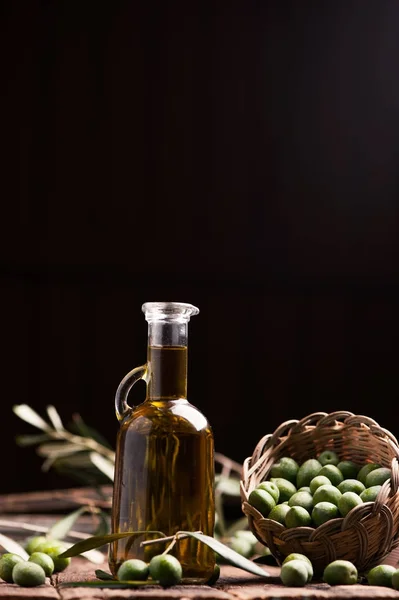 Bouteille d'huile d'olive et résout sur table en bois — Photo