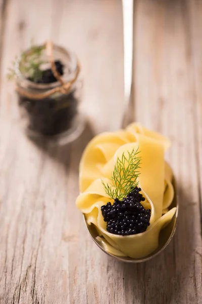 Caviar pasta tagliatelle on a silver spoon. — Stock Photo, Image