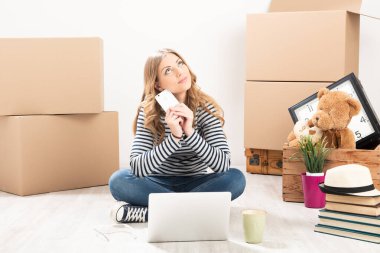 Kutuları olan genç bir kadın yeni evine taşınıyor.