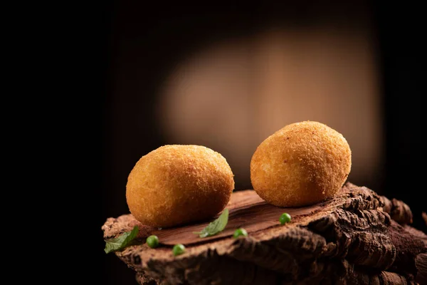 Arancini rice balls. Fried rice balls on brown wooden background — Stock Photo, Image