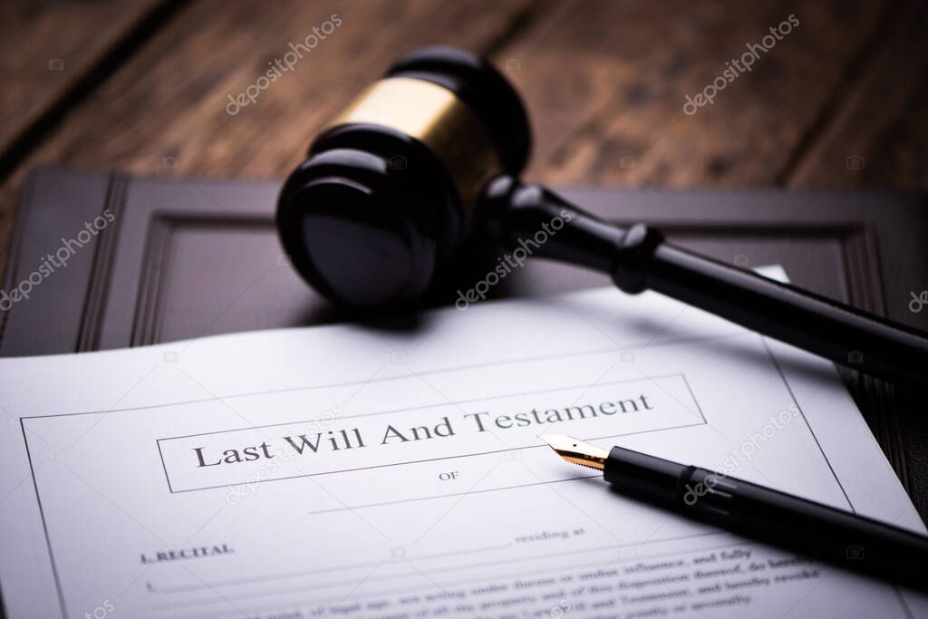 Last Will and testament document on wooden table close up