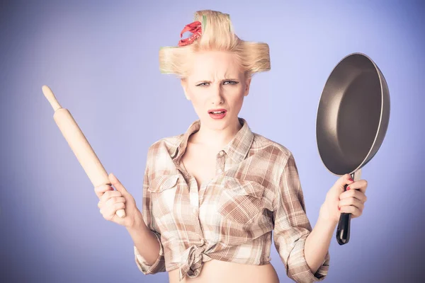 Pin up housewife with rolling pin and fry pan