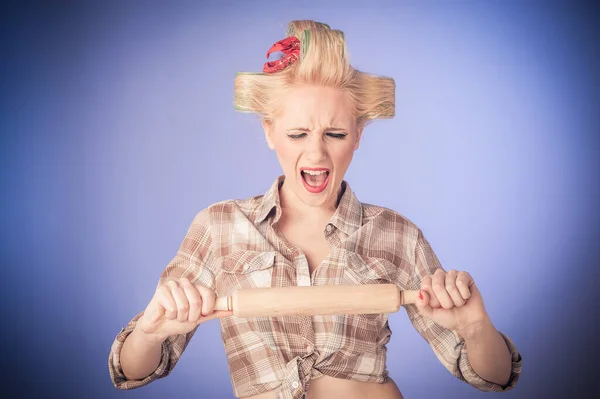 Pin up young housewife with rolling pin isolated on background