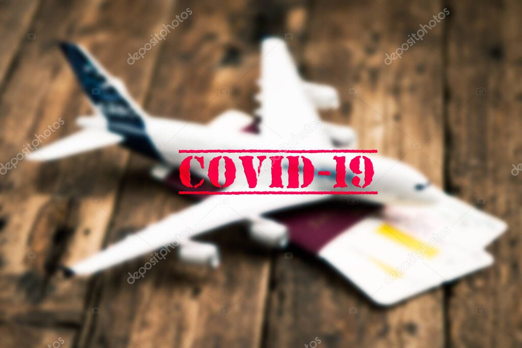 Plane model nd COVID-19 text concept. Flight cancellation due to the impact of coronavirus close up