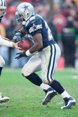 Cowboys RB Emmitt Smith takes the hand off from QB Chad Hutchinson (7) in a game against the Washington Redskins on December 29, 2002 at FedEx Field in Washington, DC.  clipart