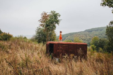 bir bebek ile küçük kız ormanda eski römork üzerinde duruyor