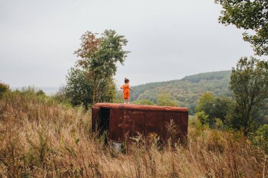 bir bebek ile küçük kız ormanda eski römork üzerinde duruyor