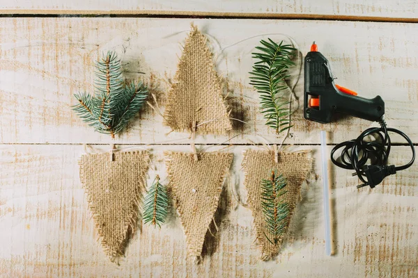 Decorative flags, glue gun and fir branches. new year decor. — Stock Photo, Image