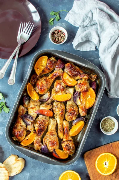 Portakal ve kırmızı soğan ile pişmiş tavuk parçaları.