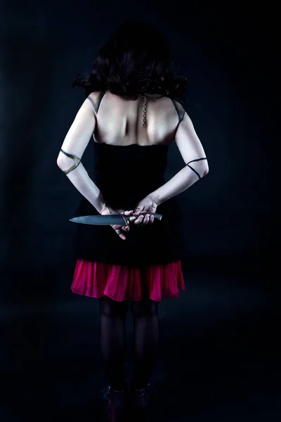 Model with makeup scary doll with knife — Stock Photo, Image