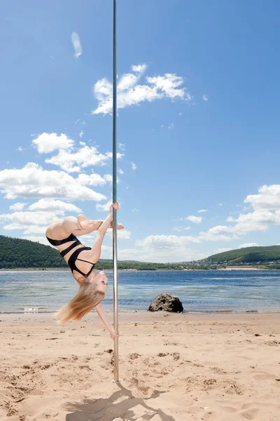 Tänzerin an Stange führt Akrobatik auf — Stockfoto