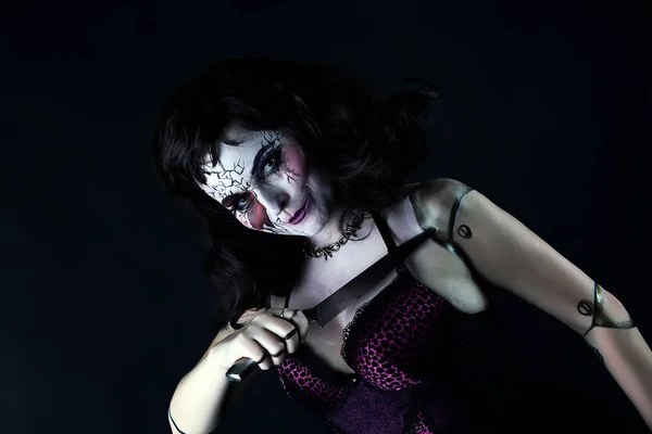 Model with makeup scary doll with knife — Stock Photo, Image