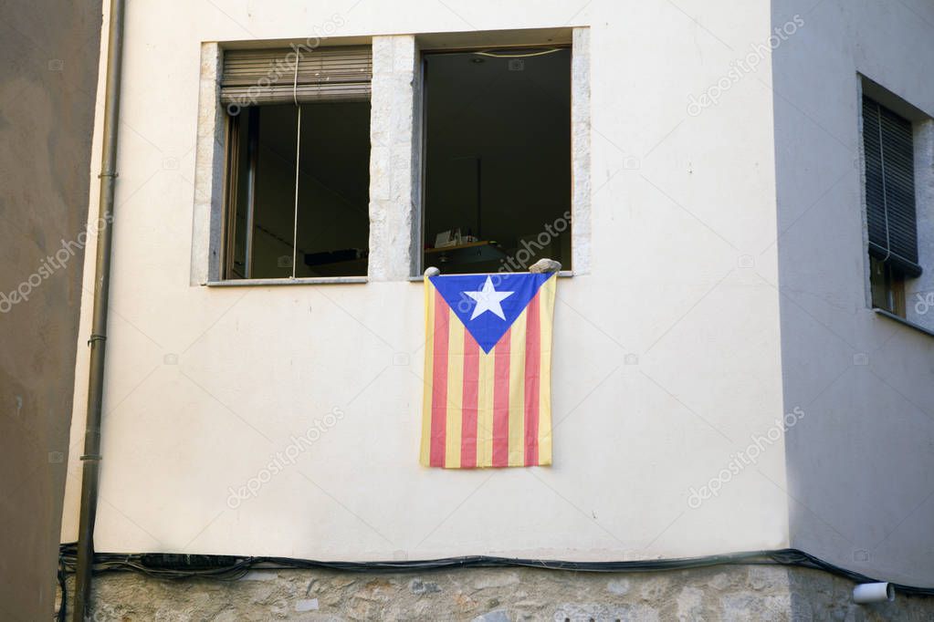 Catalan flag posted from the window of an apartment building in protest