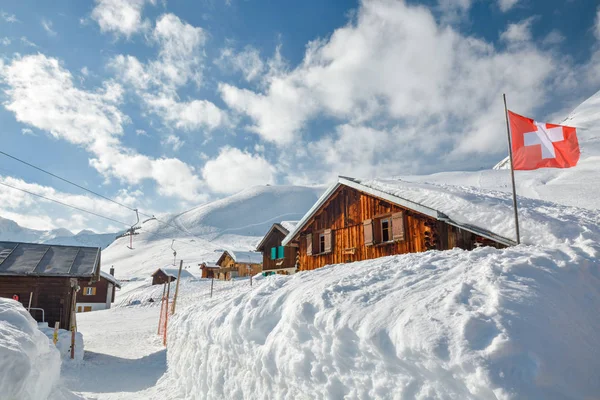 Cabañas de madera cubiertas de nieve en la estación de esquí Sedrun — Foto de Stock