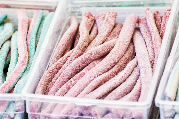 Tasty licorice candies in plastic containers — Stock Photo, Image
