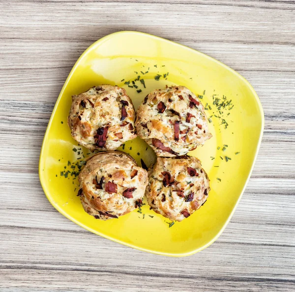 Delicious muffins stuffed with ham and cheese on the plate — Stock Photo, Image