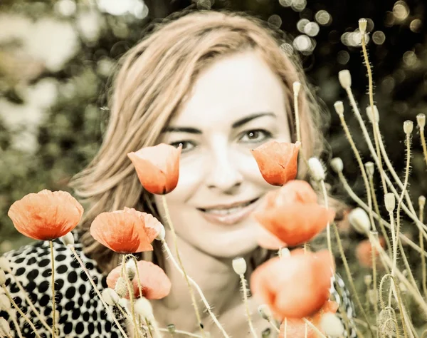 Young woman with corn poppy flowers, vintage filter — Stock Photo, Image
