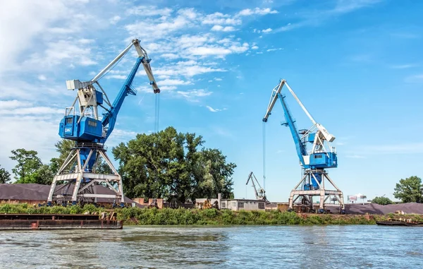 Blue cranes in cargo port, Danube river, Europe