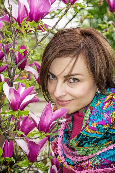 Caucasian woman with blooming magnolia — Stock Photo, Image