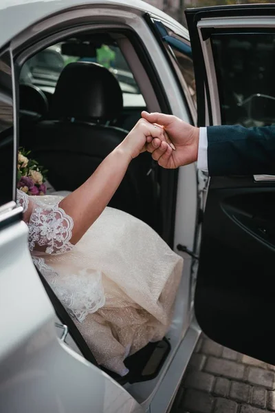 Noivo dar mãos noiva fora do carro de casamento — Fotografia de Stock