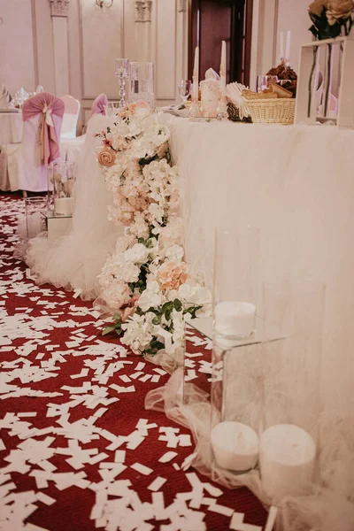 Decoración de flores de boda en el restaurante. Mesas para novios, decoradas con ramos de rosas y caramelos en tubos de vidrio — Foto de Stock