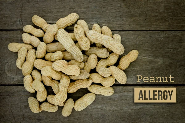 Peanut or groundnut food allergy health concept, close up on woo