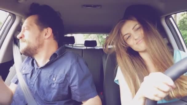 Cool funny couple dancing and singing driving car happy slow motion — Stock Video