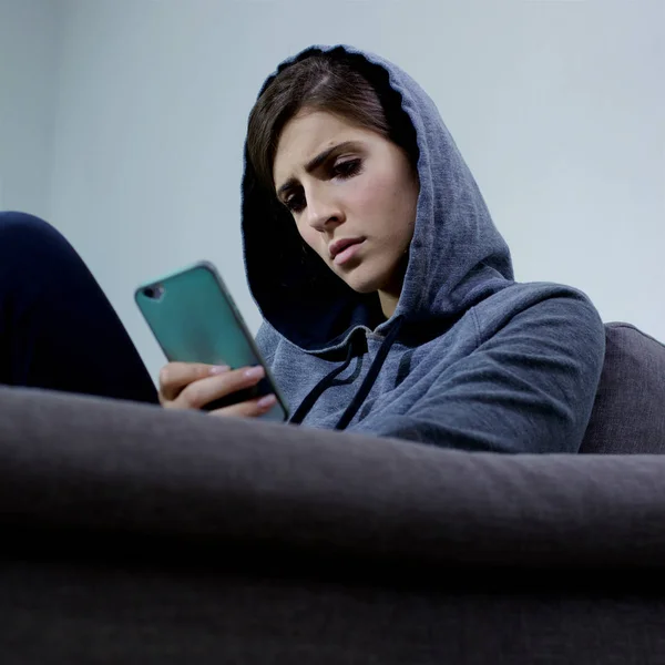 Woman sad bullied on the internet looking message on social network closeup — Stock Photo, Image