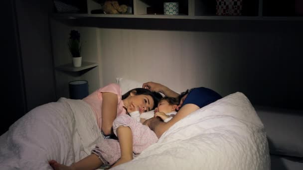 Parents essayant de dormir le matin pendant que la petite fille est éveillée — Video