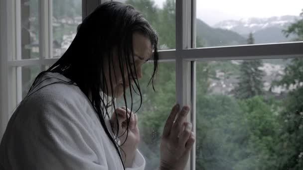 Woman with wet hair in front of window — Stock Video