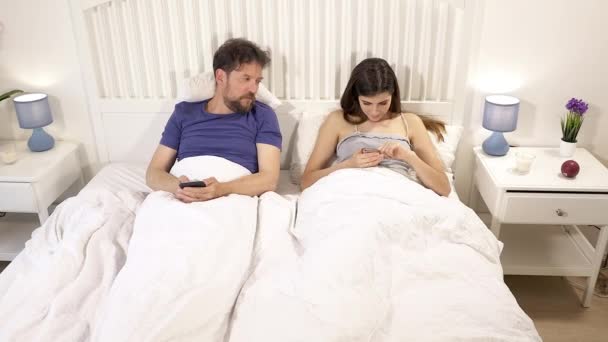 Jealous Husband Watching Bed Wife Writing Text Message Cell Phone — Stock Video