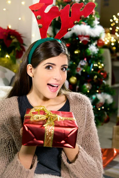 Woman holding red box christmas present smiling — Stock Photo, Image