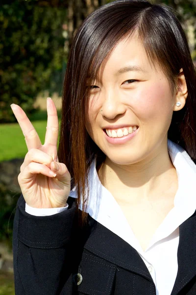 Happy asian woman victory sign smiling — Stock Photo, Image