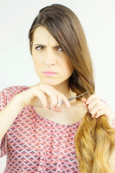 Woman unhappy about split ends hair deciding to cut all off with scissors — Stock Photo, Image